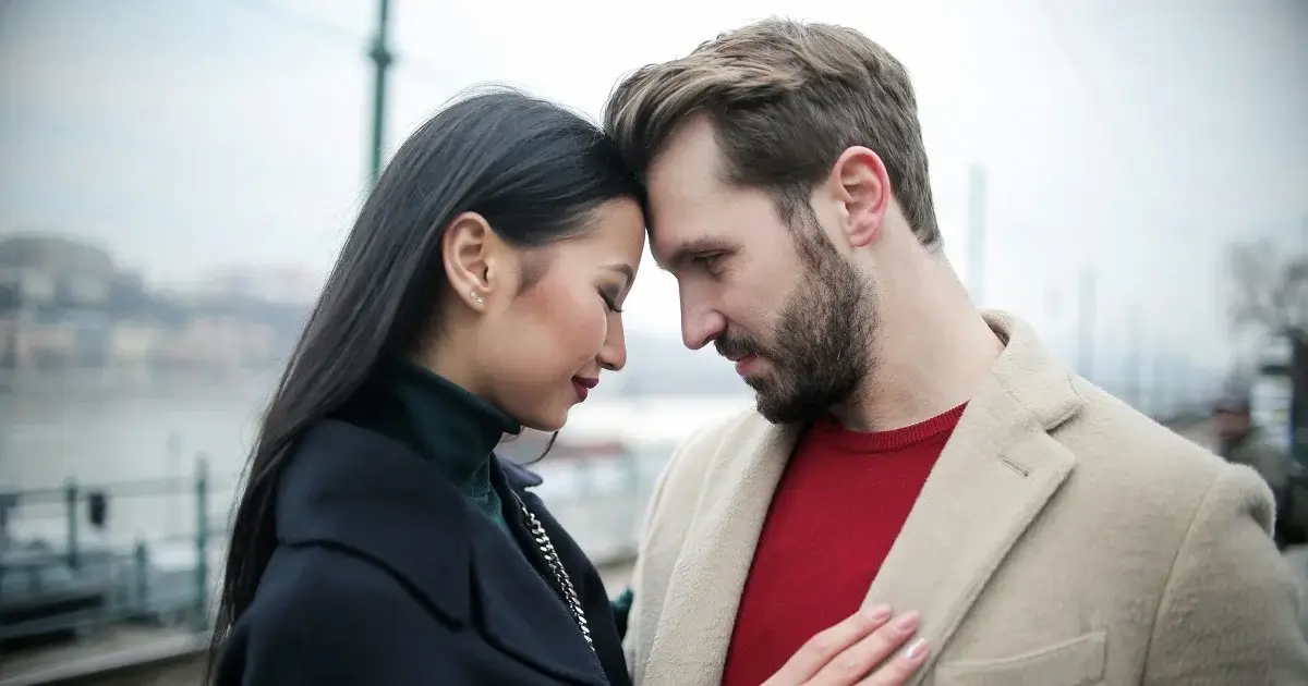 Asian woman and a white male having a romantic moment.