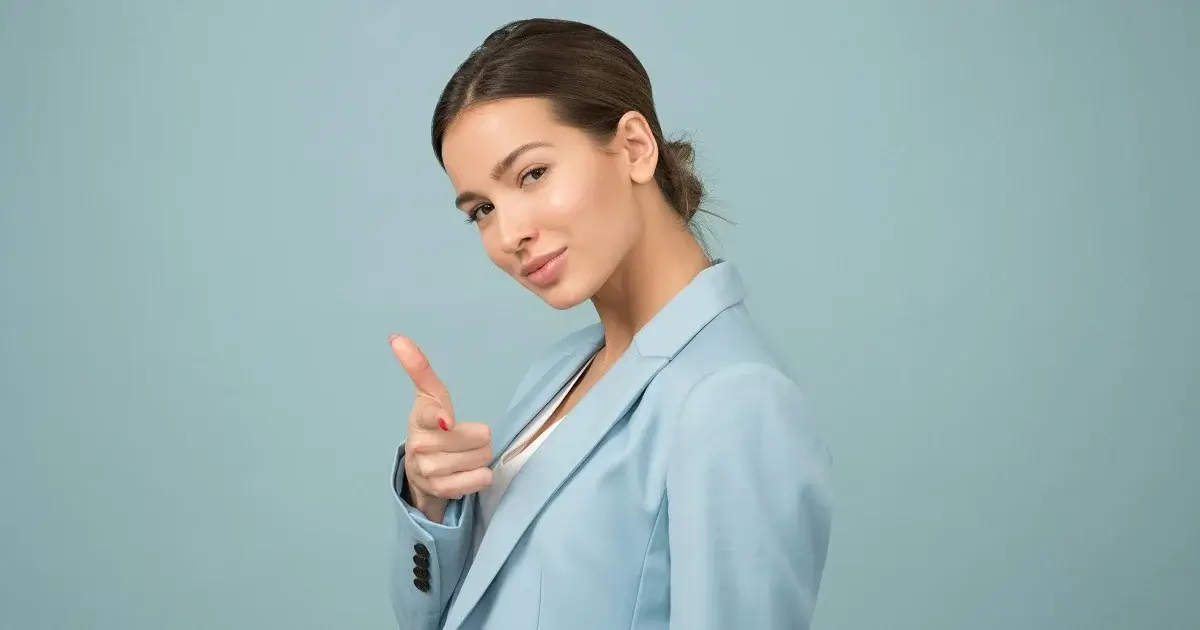 A girl doing an encouraging gesture towards the camera.