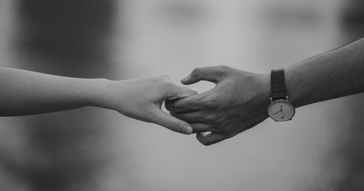 A couple holding hands in a romantic way