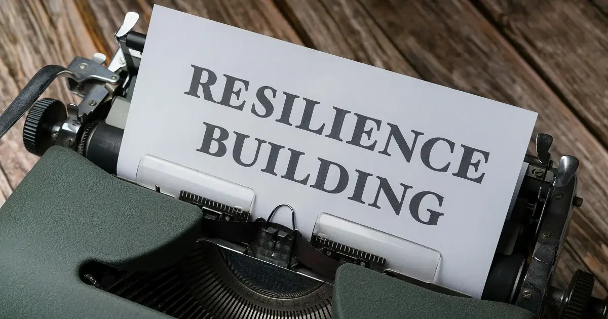 A typewriter writing the word resilience